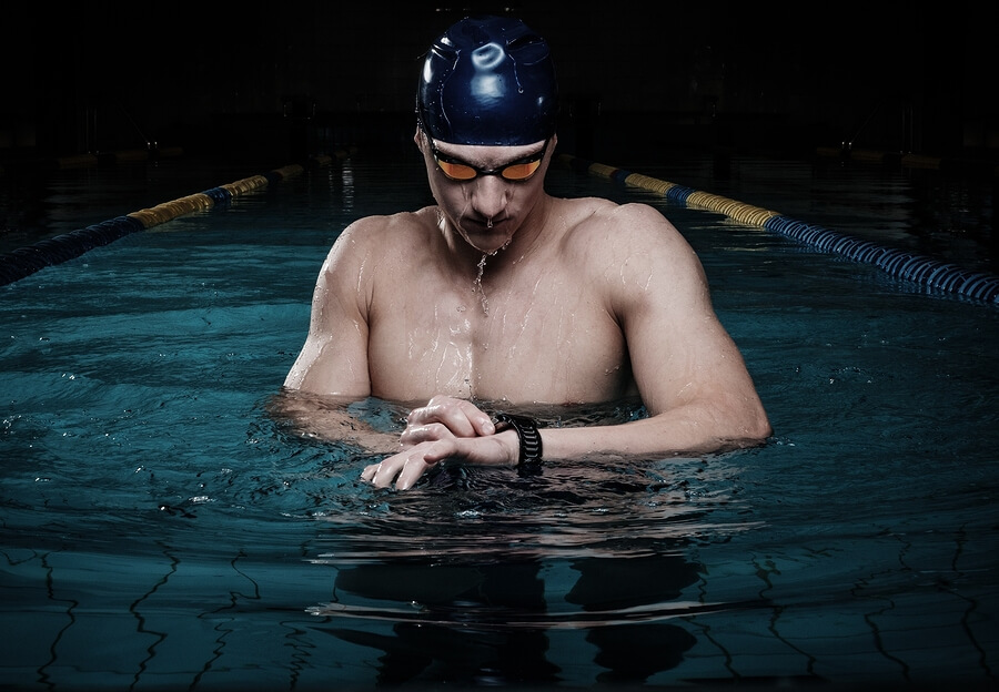 Nadador con gafas y gorro para proteger ojos y cabello.